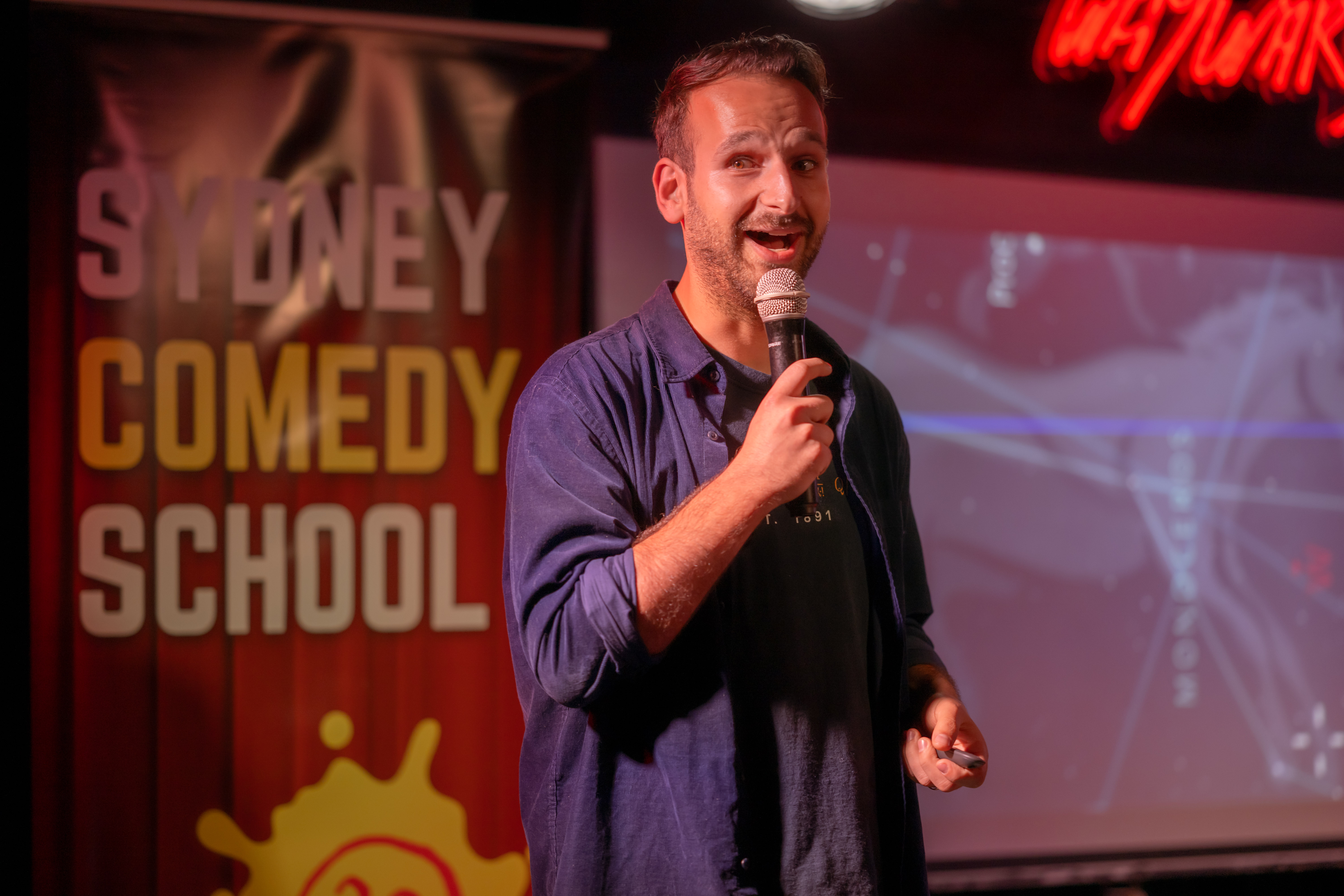 Kovi performing science comedy at Waywards, Sydney Comedy School