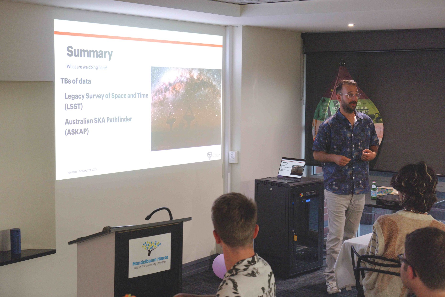 Kovi presenting radio astronomy to an audience at Mandelbaum House